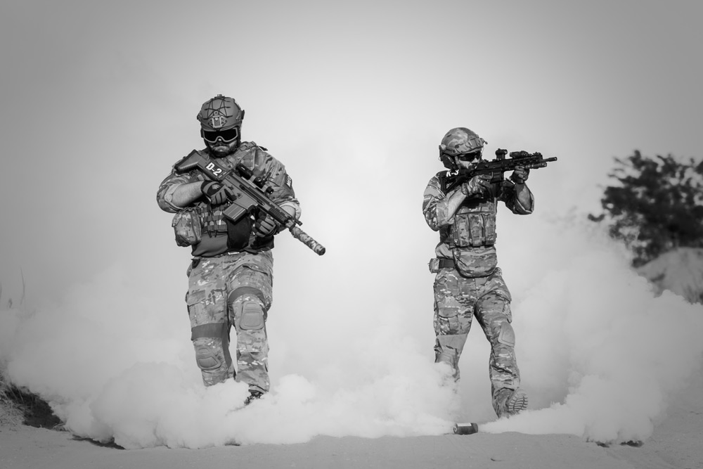 Black and white photo showing two men with guns